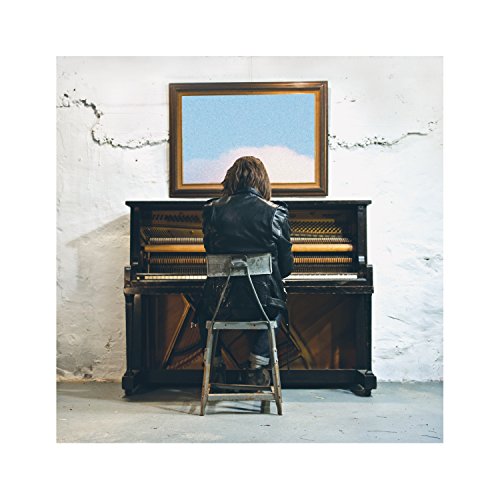 A person sits at a piano with a painting of a cloud above.
