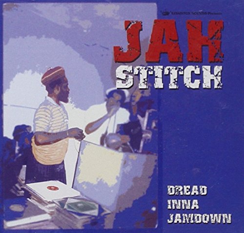 "Album cover with a man standing at a table, surrounded by CDs, against a blue background."
