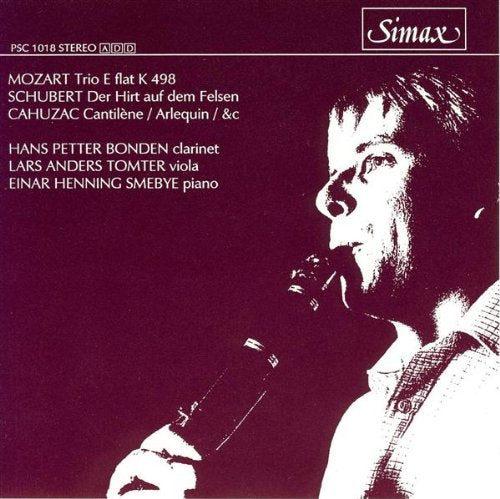 CD cover with a man holding a clarinet, maroon background, white text.