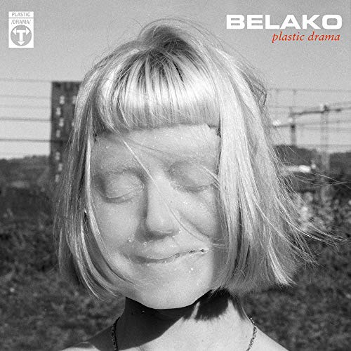 Black and white album cover featuring a woman with short hair, eyes closed, in a windy scene.