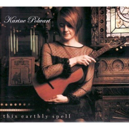"Album cover featuring a woman holding a guitar, with ornate background and text."
