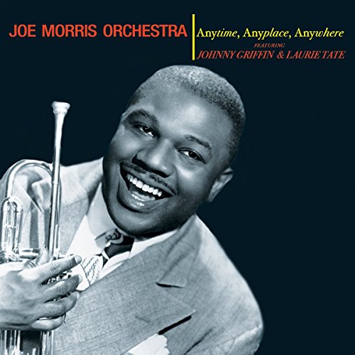 "Album cover with black-and-white photo of man holding trumpet, against dark blue background."