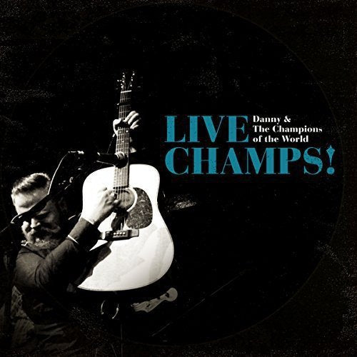 Man playing white guitar on album cover with "LIVE CHAMPS!" in blue text.