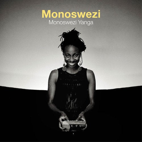 Black and white album cover with a woman holding a keyboard, smiling.
