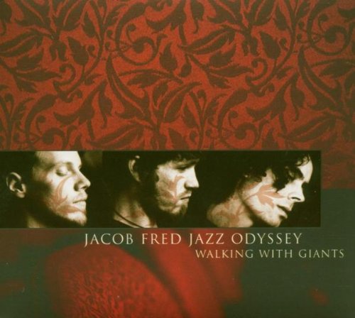 "CD cover with three men's profiles on red patterned background, titled 'Walking With Giants'."
