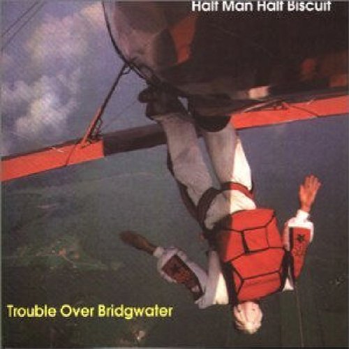 "Album cover with a man hanging upside down from a hang glider."