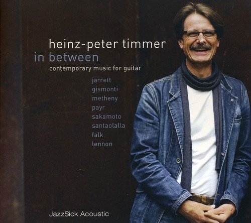 Man in denim jacket and white shirt on a music CD cover.