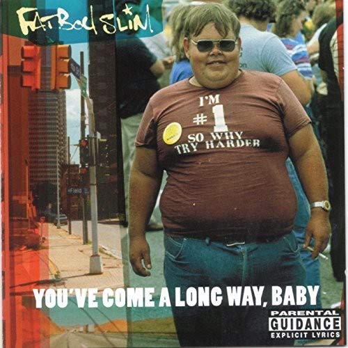 Album cover featuring a man wearing sunglasses and a t-shirt with text on a street.