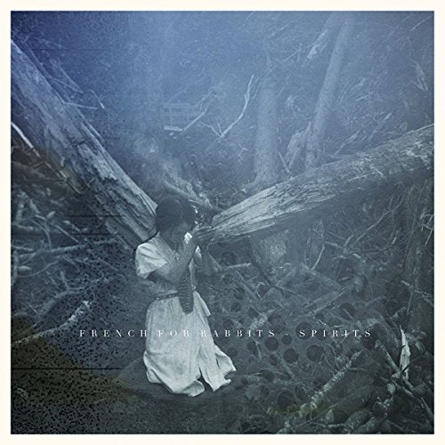 "Album cover with a woman in white dress in a dark forest."