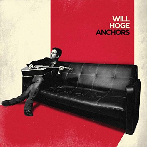 "Album cover with a man sitting on a black couch, playing a guitar."
