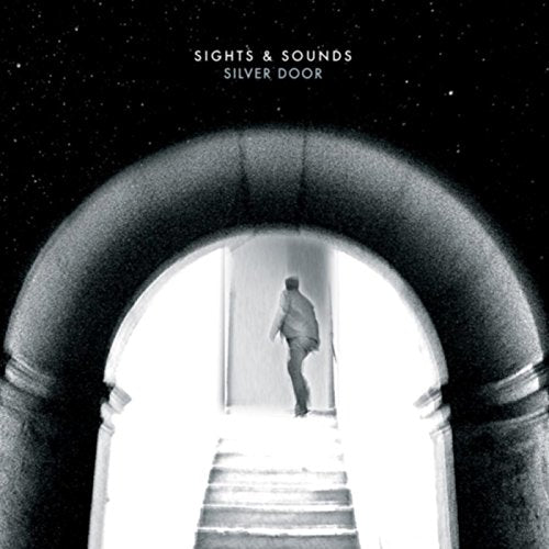 Black and white album cover featuring a person walking through a doorway into a bright space.