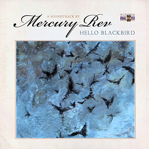 The image is a vinyl record cover. #### Alt text: "Vinyl record cover with blackbirds flying against a blue sky, titled 'Hello Blackbird'."