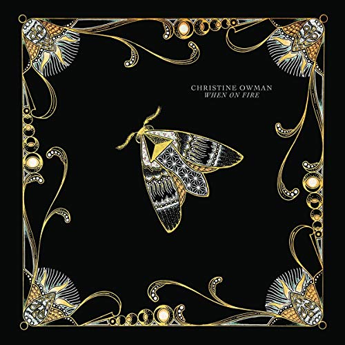 "Album cover with black background, gold border, and a moth illustration."