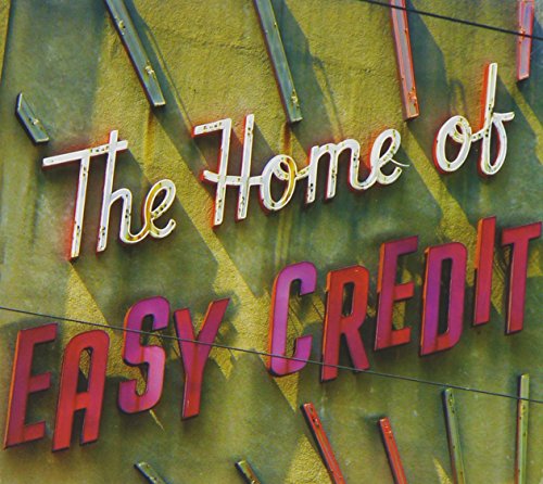 The image depicts a neon sign reading "The Home of Easy Credit". For accessibility purposes, a suitable alt text could be: "Neon sign with 'The Home of Easy Credit' text."