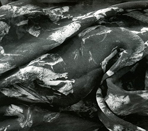 The image shows a crumpled black plastic bag with white highlights. Alt text: Crumpled black plastic bag with white highlights.