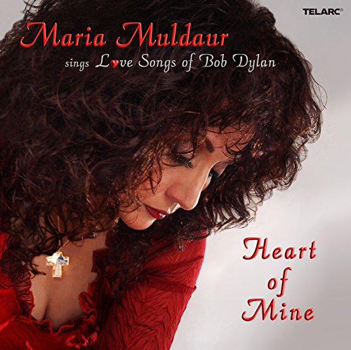 Album cover featuring a woman in red with curly hair and a cross necklace.