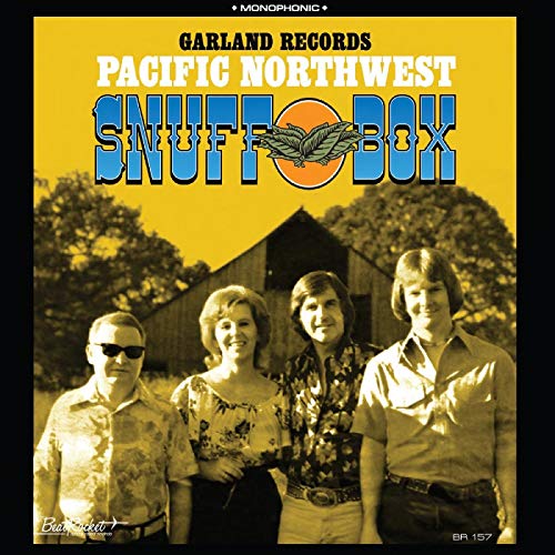 "Album cover with four men standing in front of a barn, yellow background."