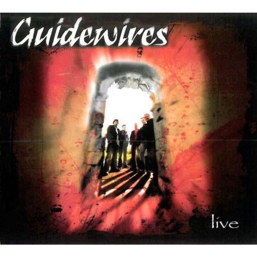 "Album cover featuring four men standing in a tunnel with red walls and bright exit."
