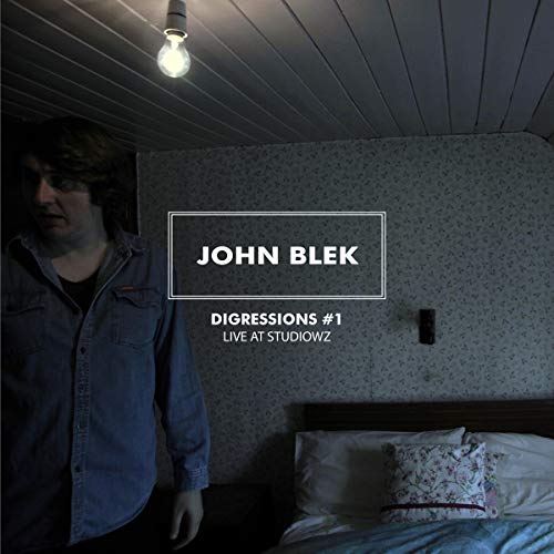 "Album cover with a man standing beside a bed under a light bulb."