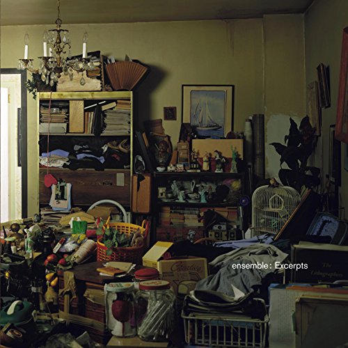 A cluttered room with a CD case and the text "Ensemble - Excerpts".