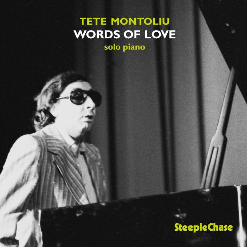 Album cover: black and white photo of a man playing piano, wearing sunglasses.