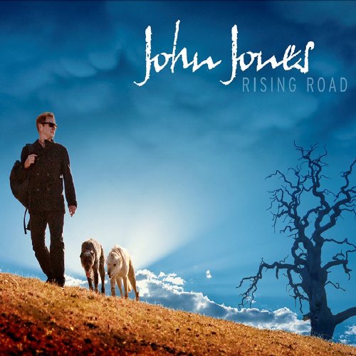"Album cover with man walking two horses on a hill, bare tree in background."