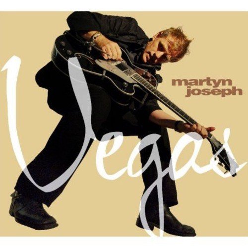 Martyn Joseph album cover: man in black playing guitar, beige background, "Vegas" in white script.