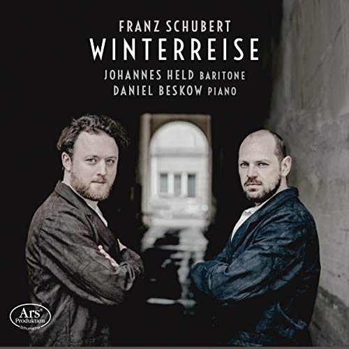 "CD cover with two men in dark jackets against a blurred background."