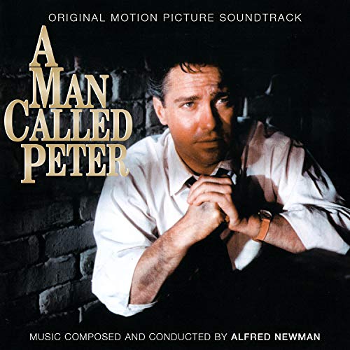 "CD cover with man in white shirt against dark brick wall, 'A Man Called Peter' title."