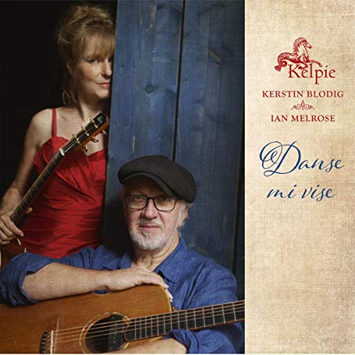 "CD cover featuring a man and woman holding guitars against a wooden backdrop."