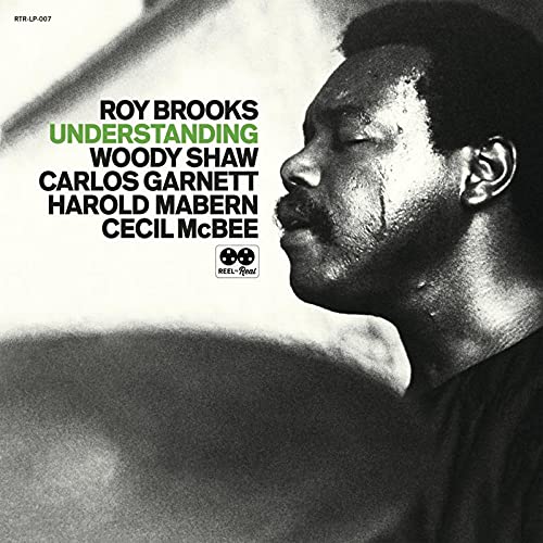 Black and white album cover with a man's profile and musician names listed.