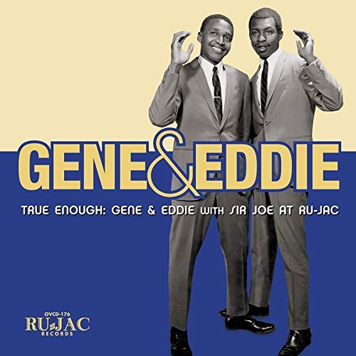 Album cover featuring two men in suits against a blue and beige background.