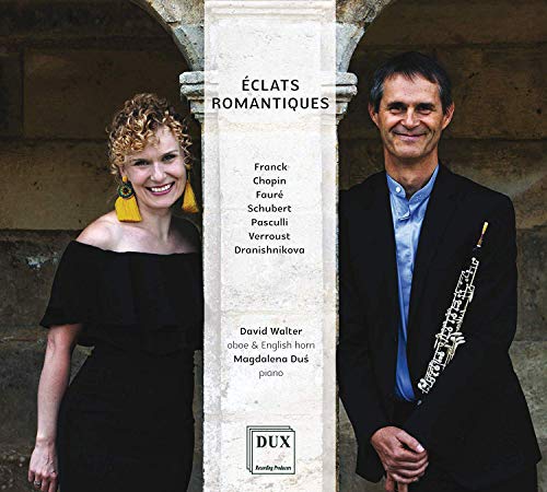 "CD cover featuring a man and woman standing beside a stone pillar."