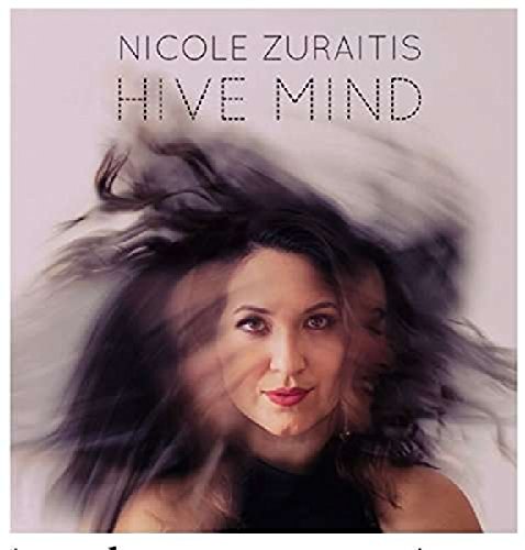 The album cover features a woman with flowing dark hair against a pale pink background.