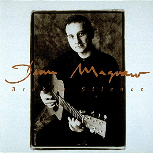 "CD cover with a man holding a guitar, sepia-toned image, artist's signature."