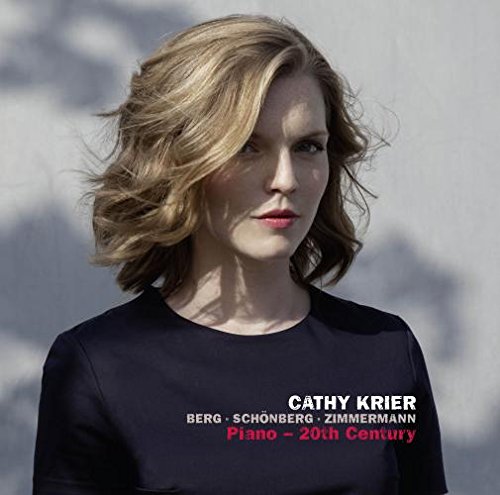 "Album cover featuring a woman with blonde hair wearing a black shirt."