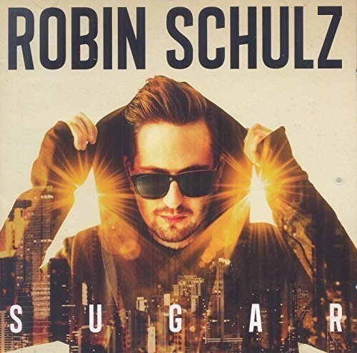 Man wearing sunglasses and hoodie with cityscape below, album cover for "Robin Schulz - Sugar".