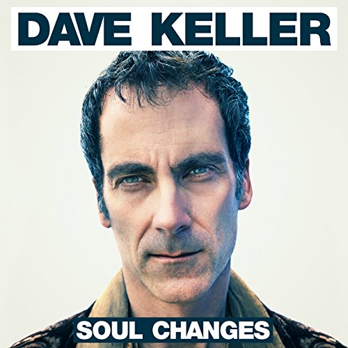 "Album cover featuring a man with short dark hair, looking directly at the camera."