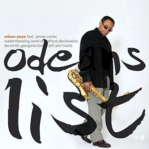 Man holding a saxophone stands beside large black text on a white background.