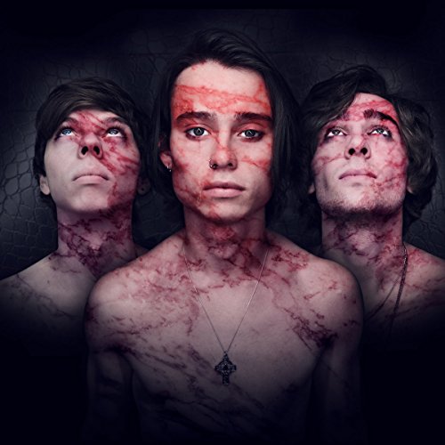 "Three shirtless men with red markings on their faces and chests against a dark background."