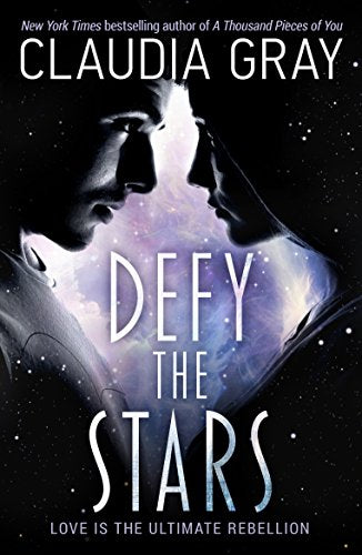 "Book cover featuring a large planet, mountains, and silhouetted figures with the title 'Defy the Stars'."