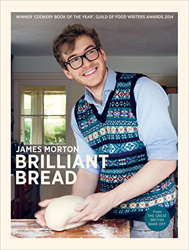 The image shows a man kneading dough on a floured surface. Man wearing a patterned apron, working with dough on a wooden surface.