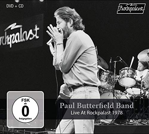 Black and white image of musician on stage with drums and "Rockpalast" logo.
