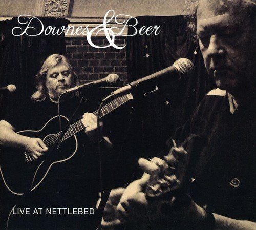 "CD cover featuring two men playing guitars and singing into microphones in sepia tone."