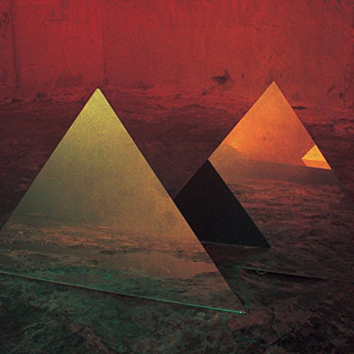 "Three pyramids in a desert landscape with a red sky, watermarked with 'UMG'."