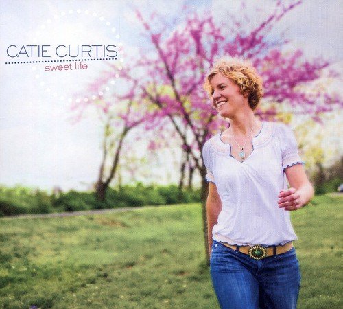 Album cover of Catie Curtis's "Sweet Life" featuring a smiling woman in a park.