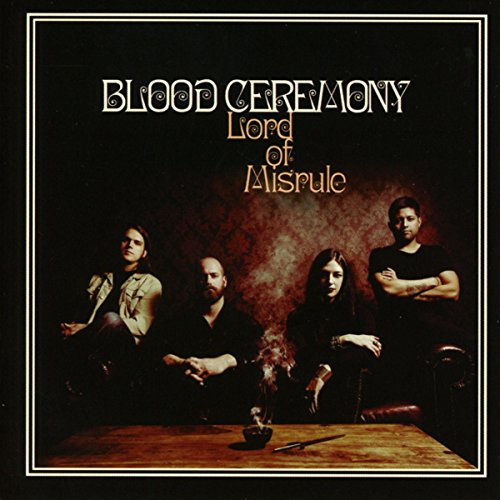 Album cover with four men seated around a table with a bloody animal head.