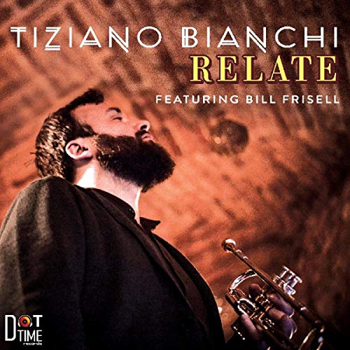 Man with beard holding trumpet, looking up, on album cover with text and logo.