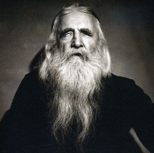 "Black and white portrait of a man with a long white beard."