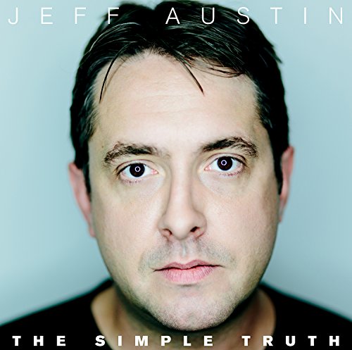 Album cover featuring a man with dark hair and a black shirt against a light blue background.